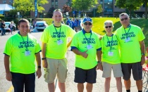 UB alumni in bright yellow shirts that read 'Proud UB Grad.". 