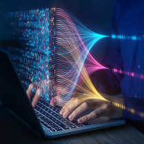 HPC specialist working on laptop with digital overlay of coding. 