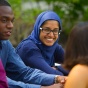 Dental students smiling, sitting outside. 
